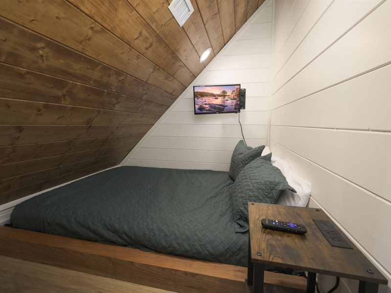 A charming nook with a queen bed, perfect for a peaceful night’s rest. Semi-private and cozy, this space is ideal for curling up with a book.