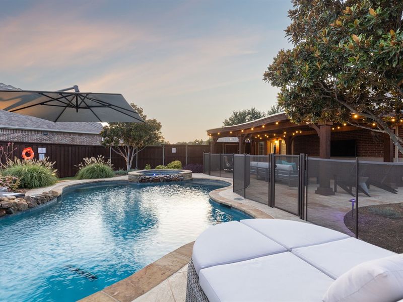 Secluded backyard oasis with gated pool, spa, and pergola.