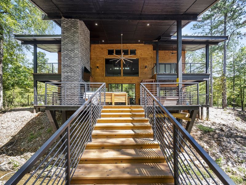 Step onto the back deck and straight into relaxation—an inviting entrance surrounded by the pines