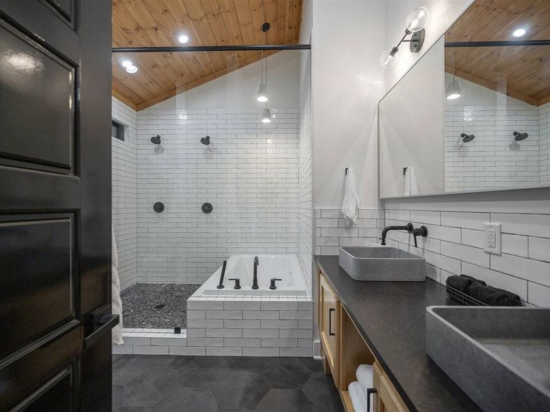 Large, walk-in shower, complete with double shower heads and 9-ft. glass to keep heat in