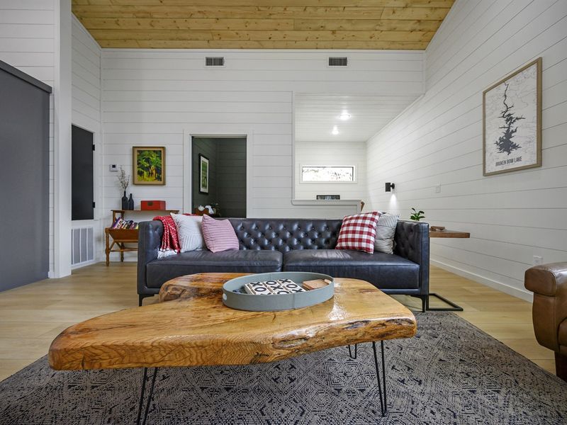 Rustic charm adorns the living space, complete with a smart TV and plush sofas.
