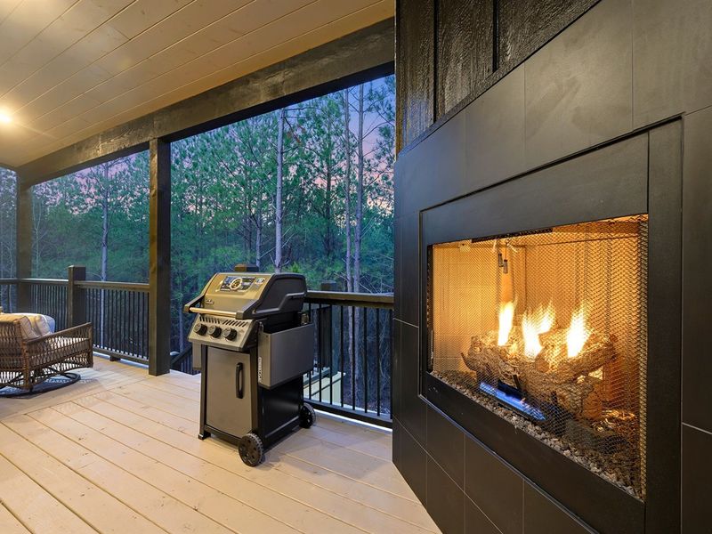Evenings made easy—fireplace glow, private hot tub, and peaceful woods.