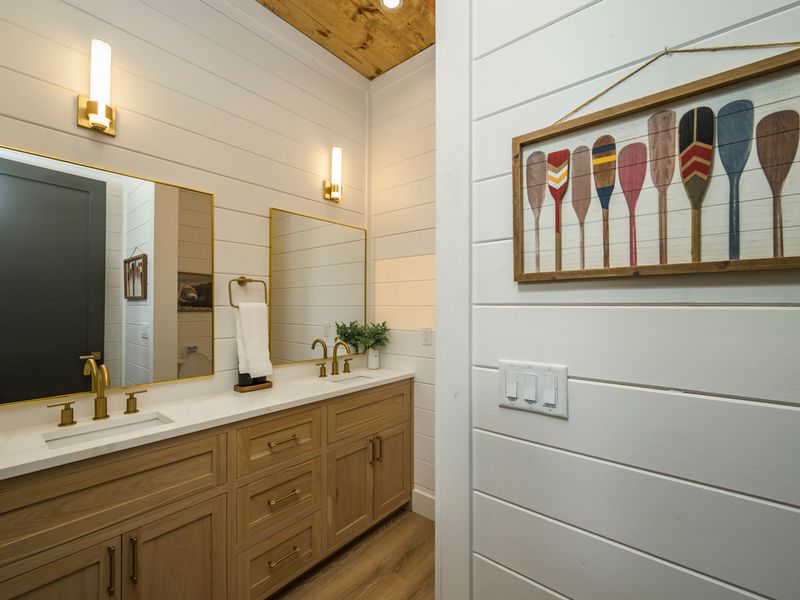 Clean lines, natural finishes, and warm brass accents give this bathroom a fresh, modern lodge feel.