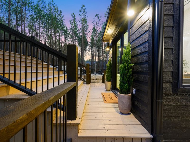 Contemporary finishes and soft evening lighting make this entry both dramatic and welcoming.