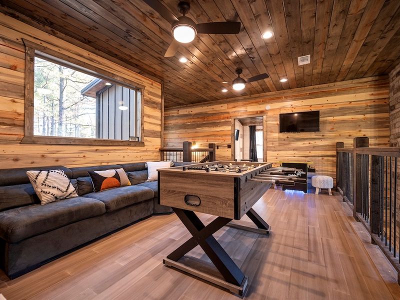 Challenge your crew to a foosball showdown, then kick back on the comfy sectional for a movie night after the fun.