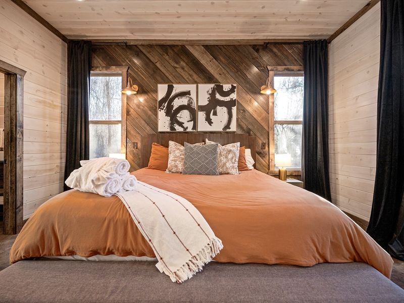 Relax in this inviting woodland suite with rich textures, abstract art, and peaceful natural light.