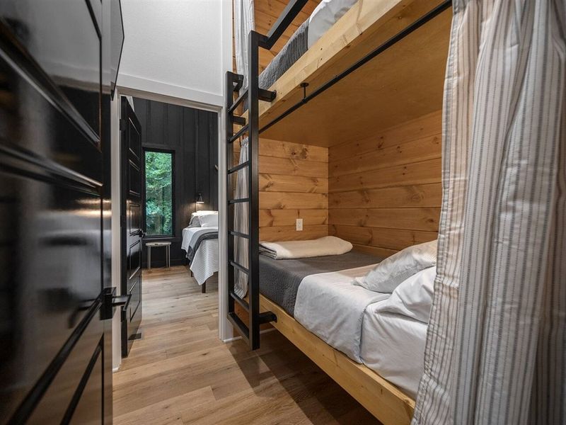 Bunk nook, complete with curtains that enclose each bunk for added privacy, dimmable lights and individual fans over each bed, and a TV with DirecTV service