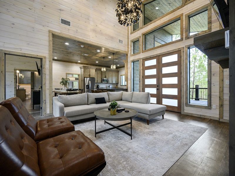 Step into the inviting ambiance of this cabin’s living room, where the beauty of nature seamlessly meets cozy, stylish design 🌲