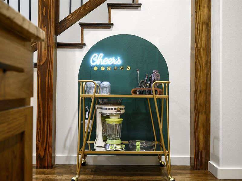 Turn every evening into a holiday with our stylish corner bar setup, where 'Cheers' shines bright.