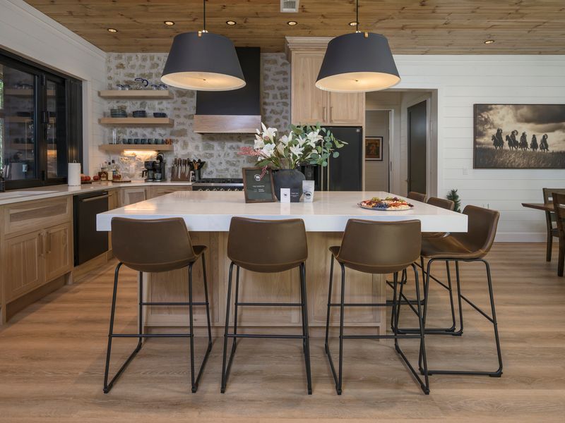 Modern kitchen at Bear Lake Lodge featuring a spacious island with seating, elegant pendant lighting