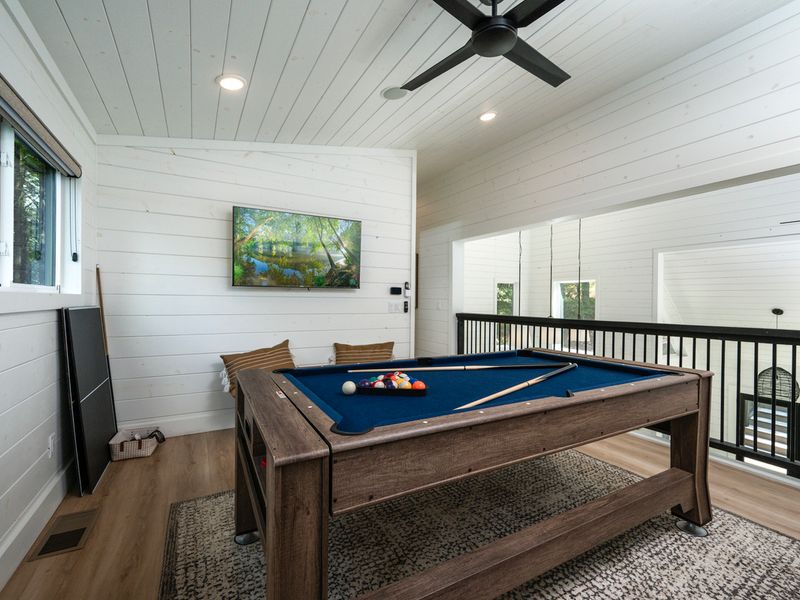 Challenge friends and family to air hockey or pool in this fun-filled upstairs game loft.