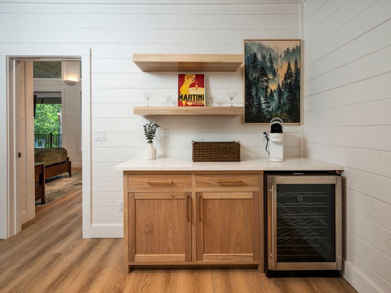 A charming beverage station is ready for morning coffee or evening cocktails, complete with a wine refrigerator and plenty of room to make yourself at home.