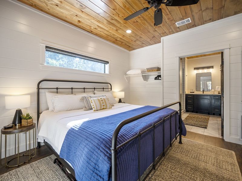 "Experience ultimate relaxation in our luxurious primary bedroom with a freestanding soaker tub and rain shower."