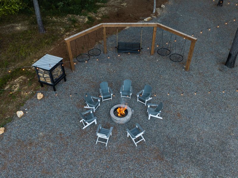 Aerial view of a cozy fire pit area at Bear Lake Lodge, featuring circular seating