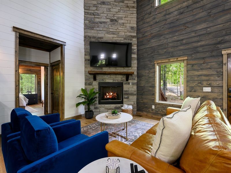 Cozy Up by the Fire: Plush couch, and 75-inch TV await in your living room bliss