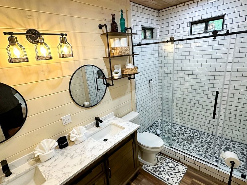 Stylish shower and sink in king bedroom 4's private bathroom.