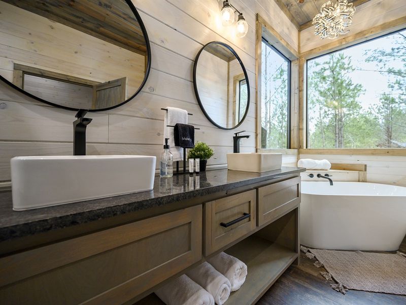 Retreat to this serene sanctuary with wooden walls and a stylish bathtub - ultimate relaxation awaits!