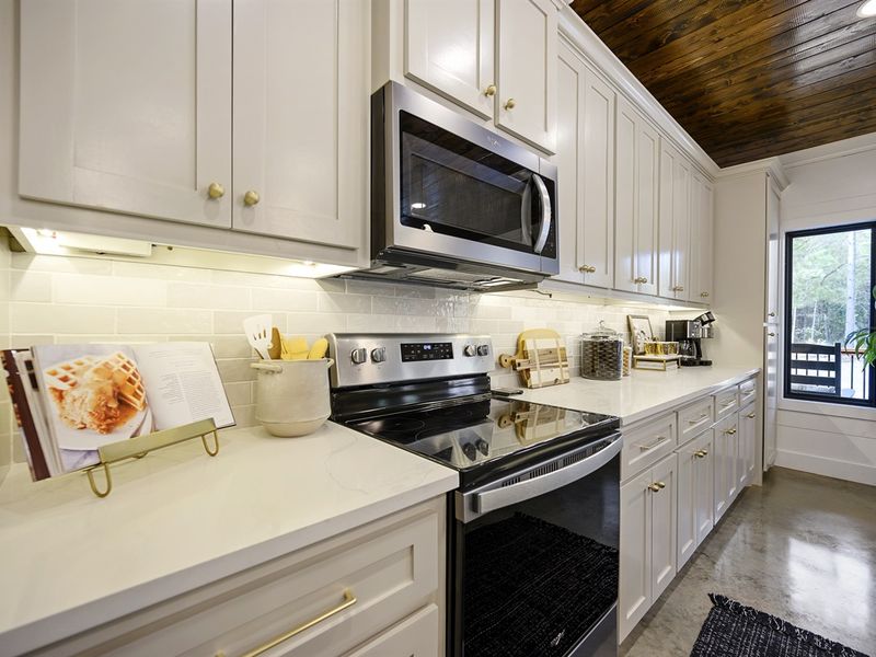 A large kitchen fully equipped with all of the cookware and bakeware you need to make full meals