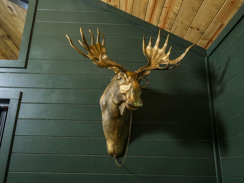 A striking golden moose adds a touch of mountain-lodge character to this one-of-a-kind game room.