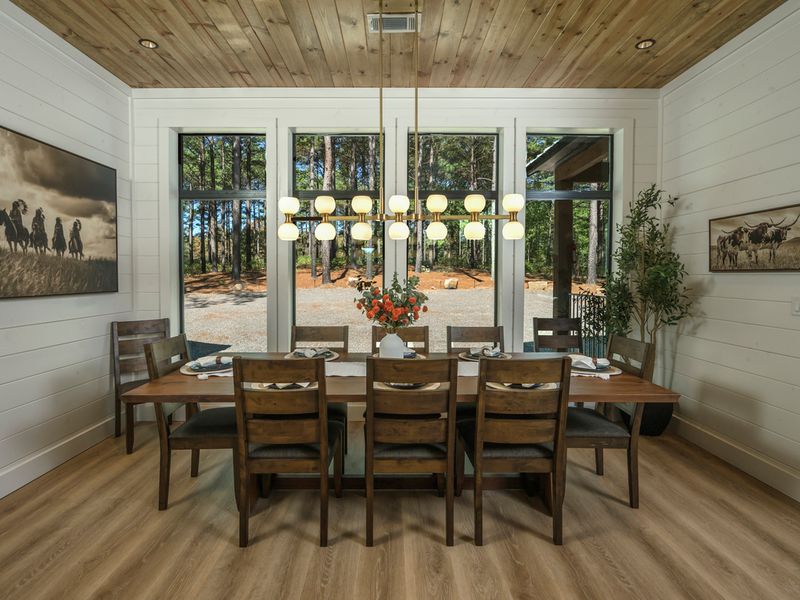 Elegant dining room at Bear Lake Lodge featuring a large farmhouse-style table set