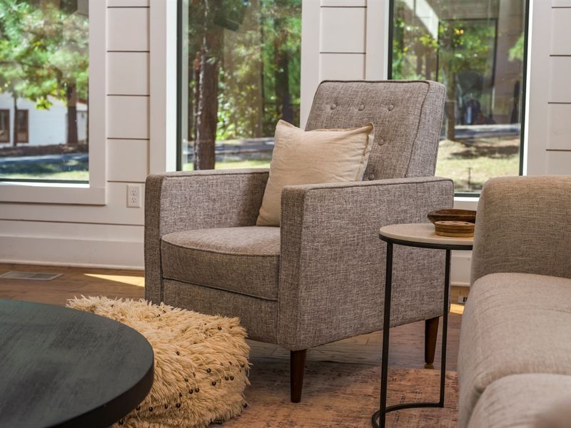 A cozy reading corner with forest views—perfect for slow mornings and quiet moments at our Broken Bow cabin