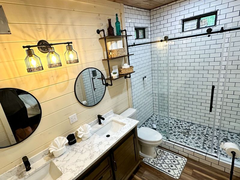 Upstairs king bedroom's modern ensuite bathroom with sleek shower and elegant sink.