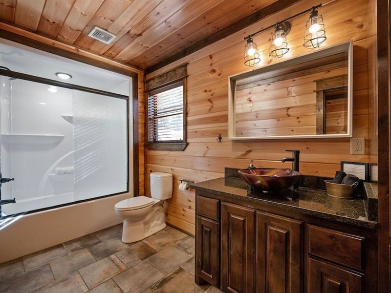 Third bathroom upstairs with access to third king bedroom & game room.