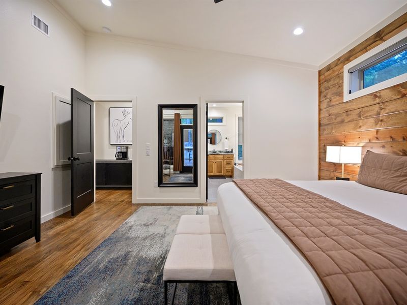 “Spacious master suite with cozy wood accents and ensuite spa bath — your peaceful retreat in the pines.”