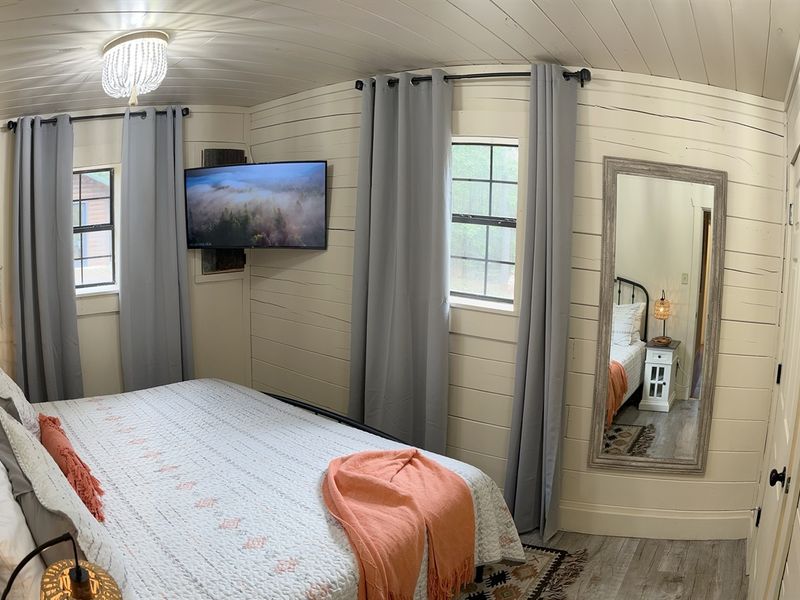 Luxurious king-size bed in the second bedroom with Smart TV.
