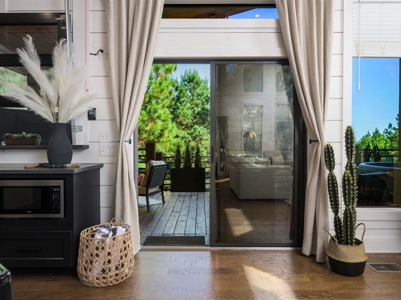 Sunlight, forest views, and seamless indoor-outdoor living — step right out onto the deck and let the cabin life begin