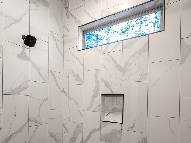 Refresh in the spa-inspired walk-in shower with beautiful tile and natural light.