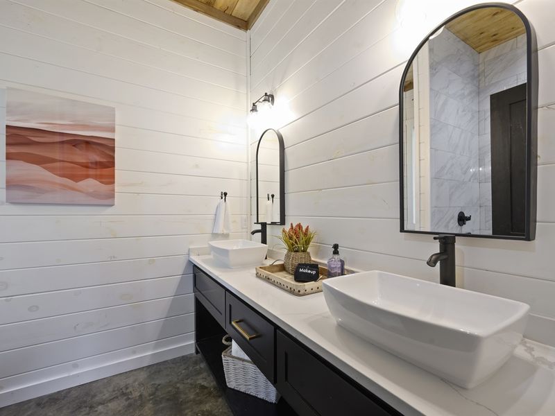 The ensuite features double sinks and a walk-in shower