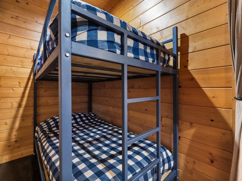 This upstairs bunk room is the perfect escape, featuring twin-over-twin bunks, making it a private space kids and teens will love.