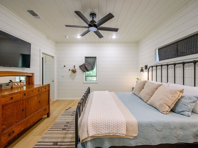 Step into this serene sanctuary featuring a comfy bed and a stylish ceiling fan - perfect for peaceful nights and lazy mornings.