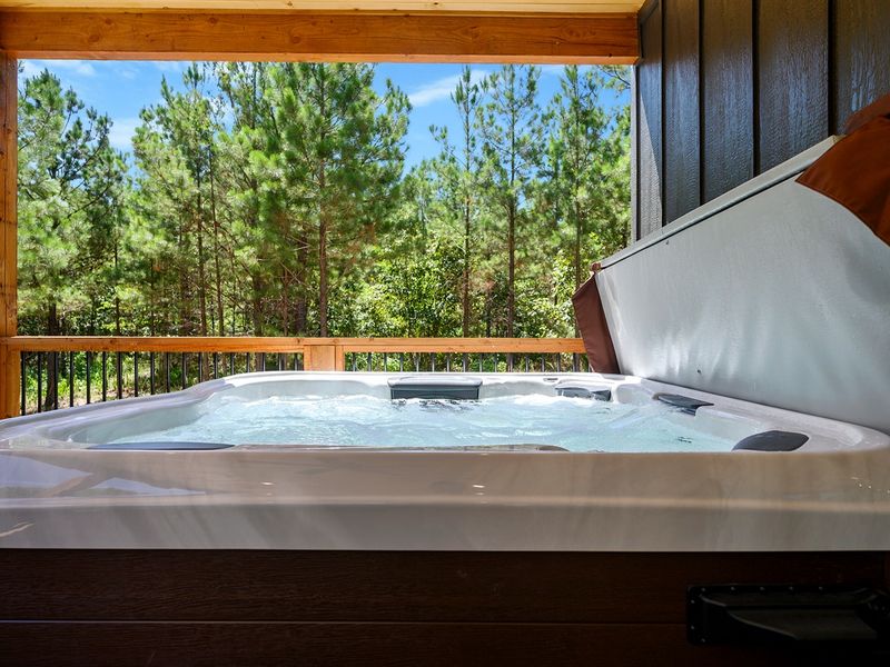 Soak in your private hot tub surrounded by tall pines—pure relaxation at our Broken Bow cabin retreat