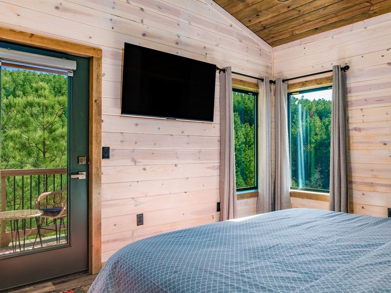 Catch sunsets from bed or binge your favorite shows - why not both? Bedroom 5