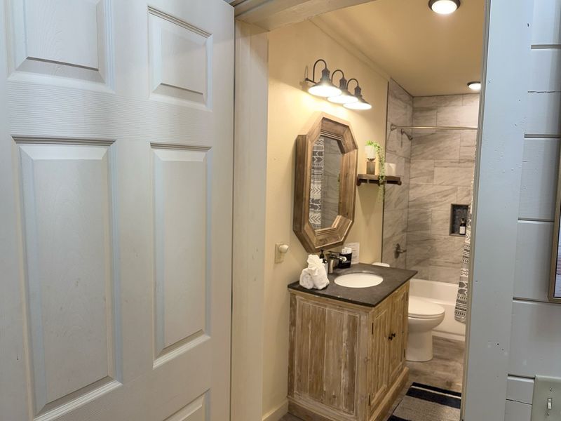 Tranquil escape with contemporary tub and sleek sink.