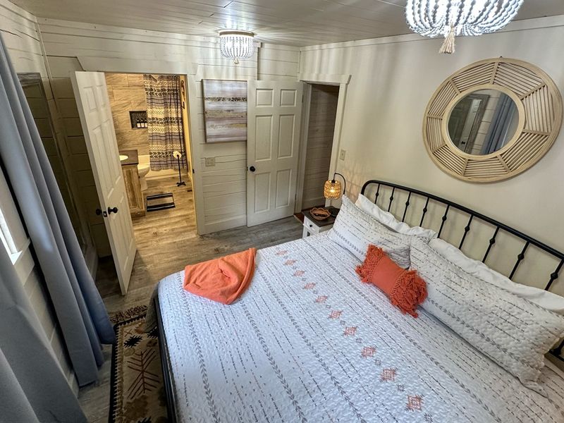 Comfort awaits in our king bedroom with attached bathroom at the main cabin.