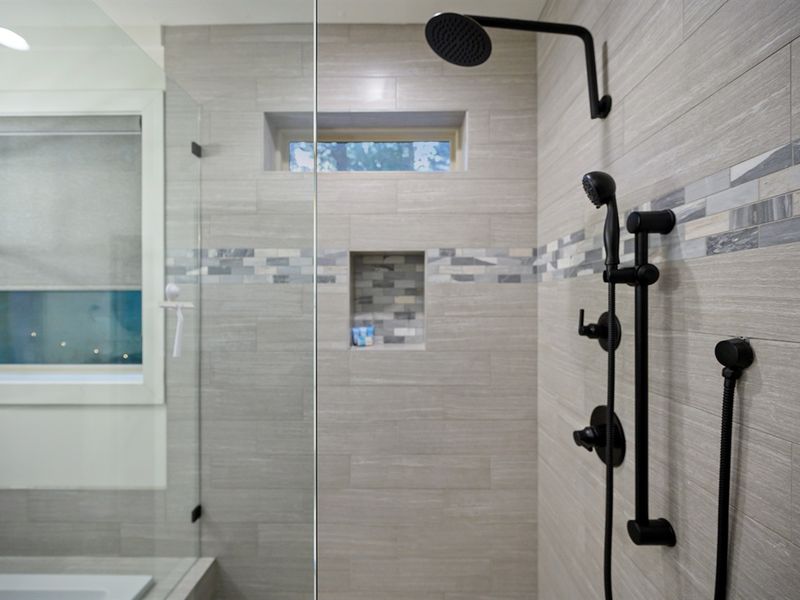 Modern spa shower with rainfall and handheld jets — sleek design, soothing tile, and the perfect finish to a day exploring Broken Bow.