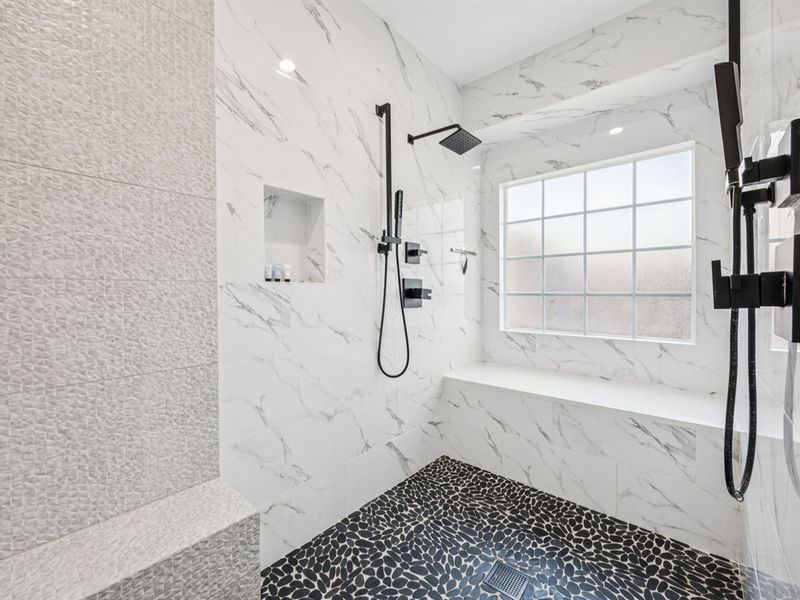 Spa-style bath with dual rain showers and dog-wash bench.