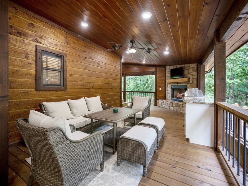 "Revel in al fresco dining amidst the whispering pines on our breezy covered deck."