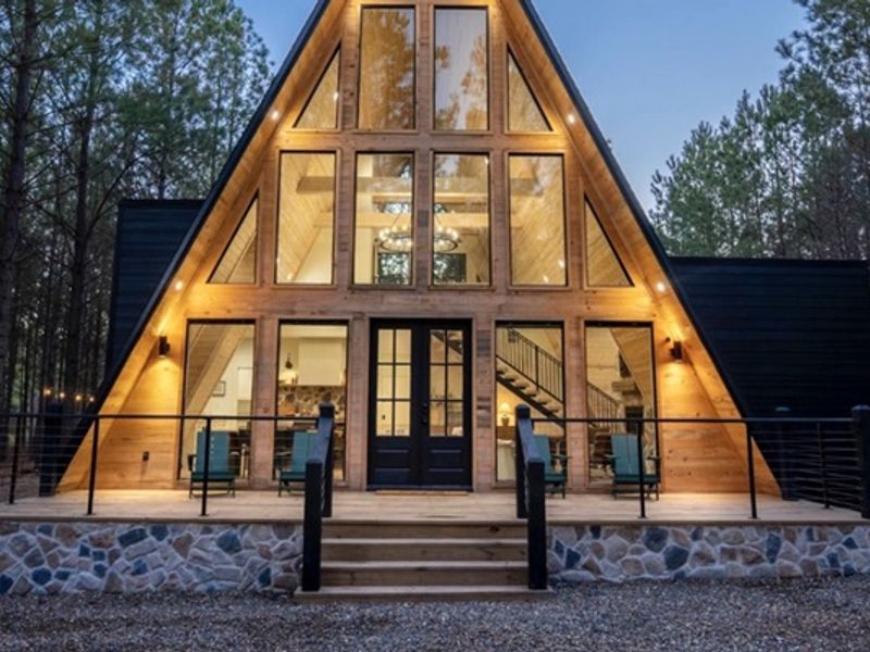 "Embrace the serenity: Our A-frame cabin, where modern design meets the rustic charm of the forest."