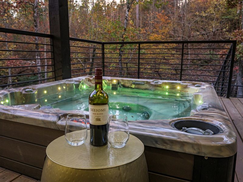 Escape to the pines… come stay with us and enjoy a private hot tub, sparkling lights, and a glass of wine under the trees