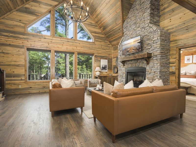 Cozy up by the stone fireplace with peaceful forest views