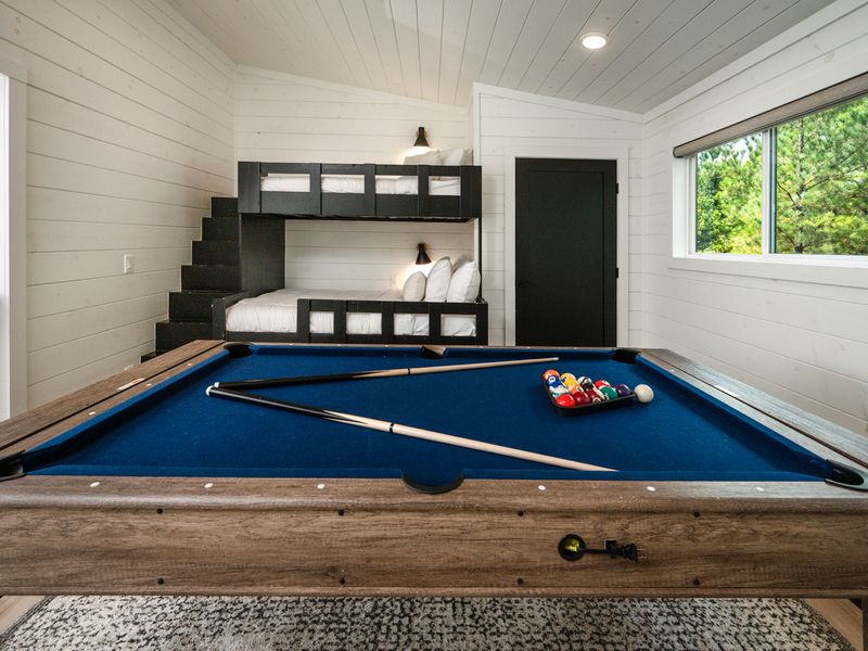 Spacious loft with custom built-in bunk beds and a full-size game table for family fun.
