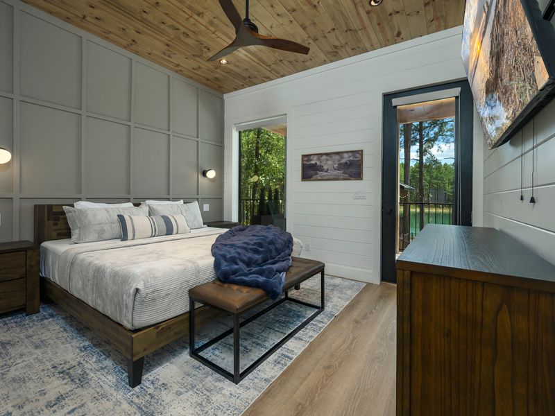 Wake up surrounded by natural light and peaceful woodland views in this beautifully appointed bedroom, featuring a comfortable king bed, warm wood accents, and a private door leading to the deck.

You&rsquo;re