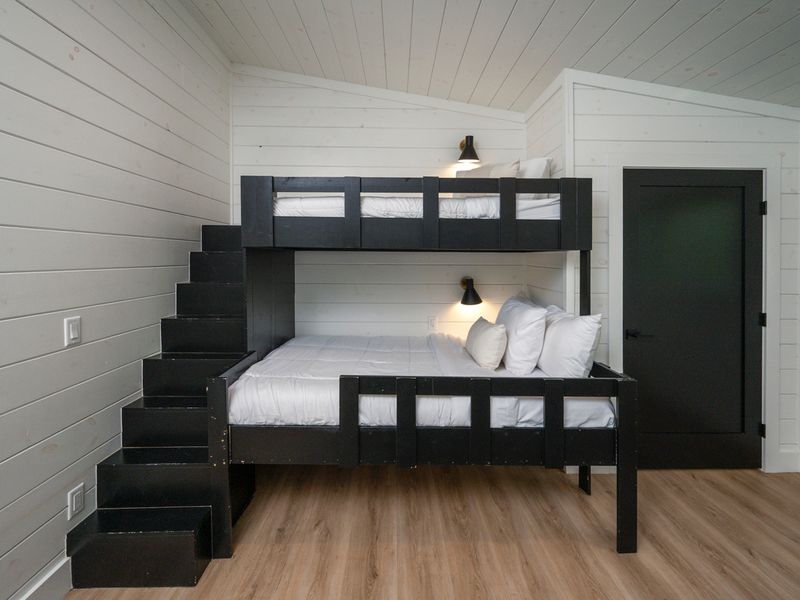 Custom bunk beds with built-in stairs create a fun, comfortable retreat for kids and teens.