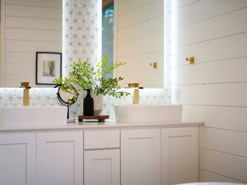 The double vanity with modern vessel sinks provides plenty of space to get ready.