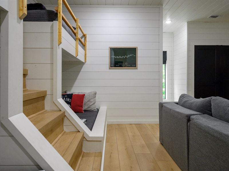Couches and bunk beds - the ultimate combo for a cozy sleep and movie marathons!