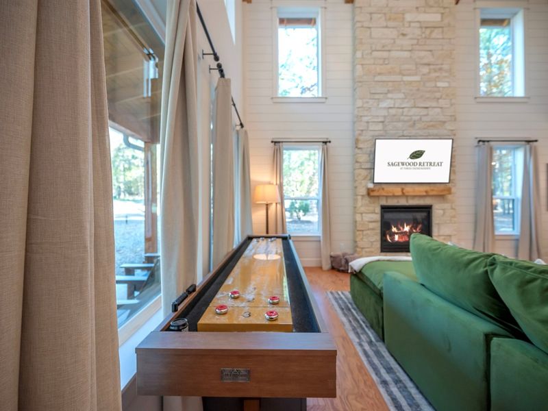 The best kind of game night: crackling fireplace, soft lighting, and shuffleboard ready to play. 🔥🤎